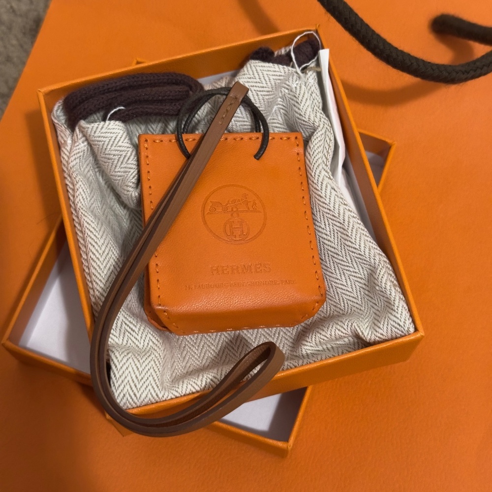 Hermes orange shopping bag lamb skin leather charm.